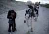 Touching Photo Captures Guatemalan Mother Begging Soldier To Let Her Into U.S. Soldier
