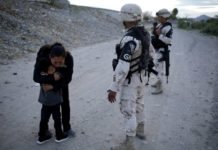Touching Photo Captures Guatemalan Mother Begging Soldier To Let Her Into U.S. Soldier